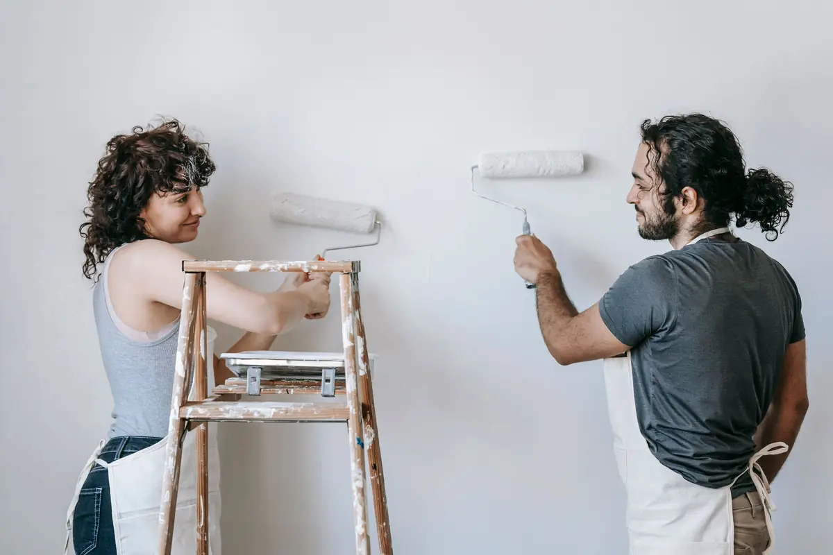 People painting a wall together — painting help in Sioux Falls